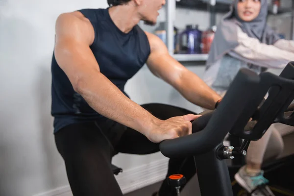 Muslim woman hijab and friend at the gym doing cardio exercises