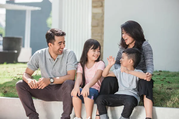 Happy asian family in front of their house — Stock Photo, Image