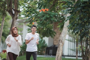 İki koşucu egzersiz üzerinde çalışıyor ve ısınmak