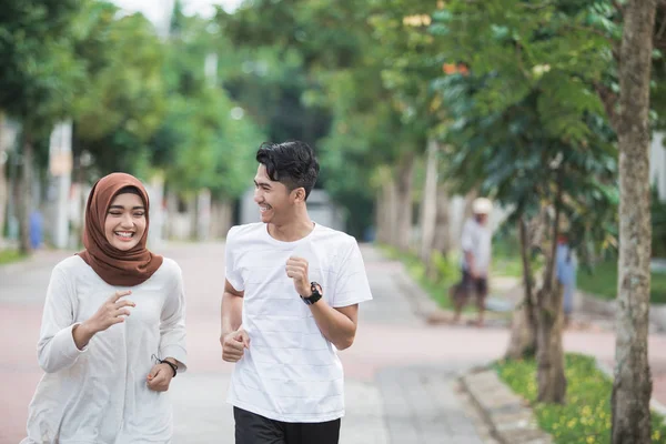 happy young asian couple exercise and warm up