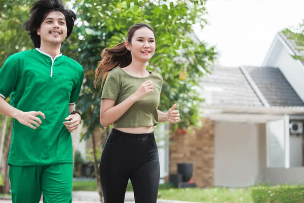 Couple jogging and running outdoors in nature