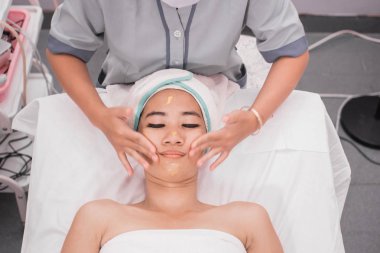 beautician giving facial massage clipart