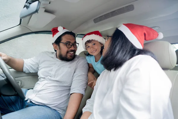 family on vacation driving a car