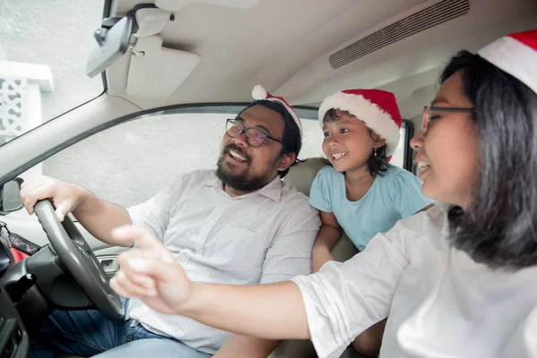 family on vacation driving a car