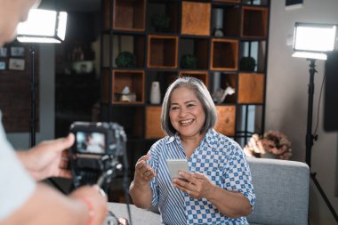 Yaşlı kadınlar cep telefonu teknolojisi üzerine video çekiyor.