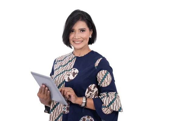 Close up asian woman with a smile holding a digital tablet looking at a camera — Stock Photo, Image