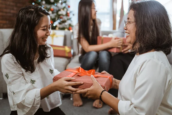Córka daje jej mama prezent na Boże Narodzenie — Zdjęcie stockowe