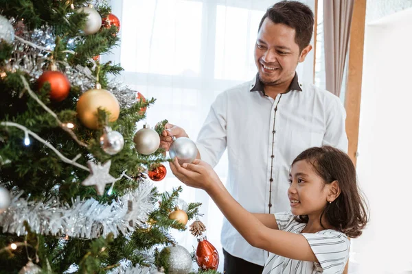 Ασιάτης πατέρας και κορίτσι διακοσμούν χριστουγεννιάτικο δέντρο — Φωτογραφία Αρχείου