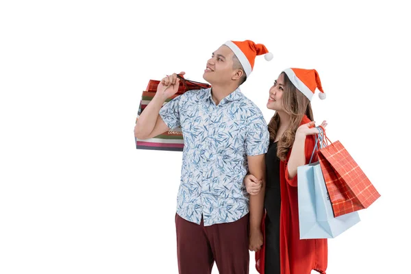 Casal com chapéu de Natal olhando para copyspace — Fotografia de Stock