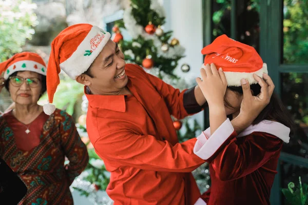 Baba kızına Noel şapkası verdi. — Stok fotoğraf