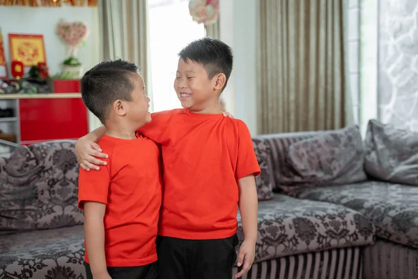 Dos niños sonríen en camisas rojas —  Fotos de Stock