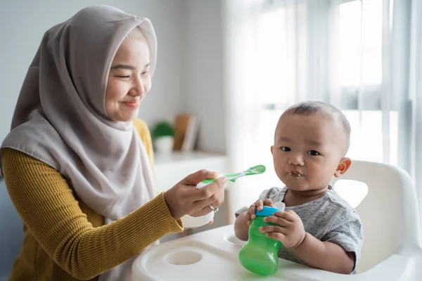 亚洲母亲用勺子喂小儿子 — 图库照片