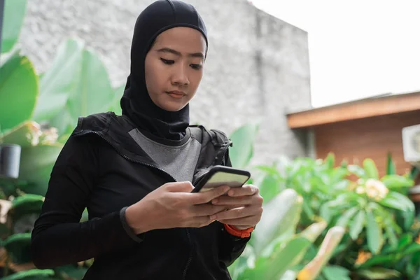 Asiatische muslimische Frauen tragen Hijab-Sportbekleidung mit Smartphone — Stockfoto
