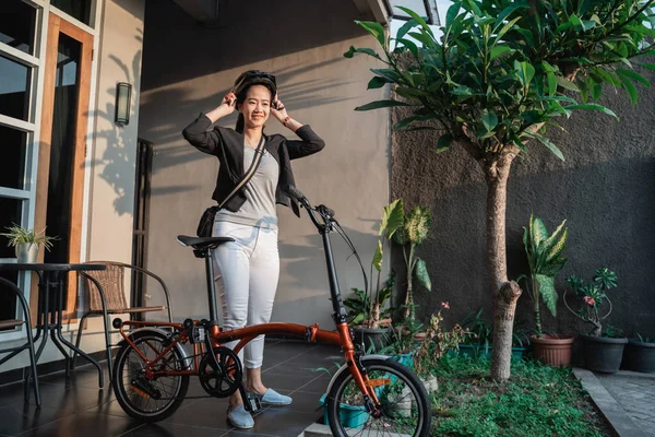 Ásia jovem mulher vestindo capacete bicicleta para segurança — Fotografia de Stock