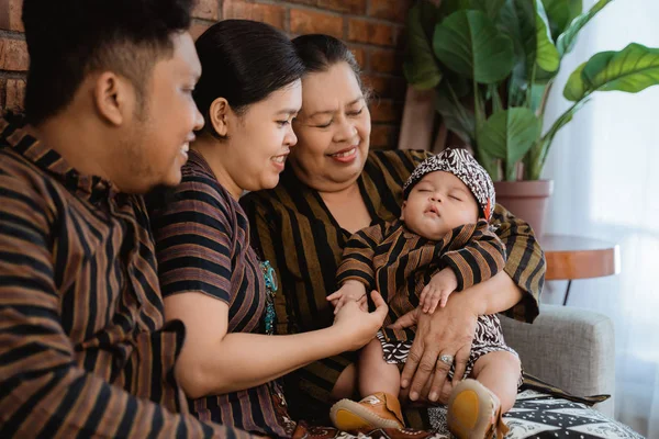 Asiatische glückliche Familie sitzt im javanischen Batik-Erbe — Stockfoto