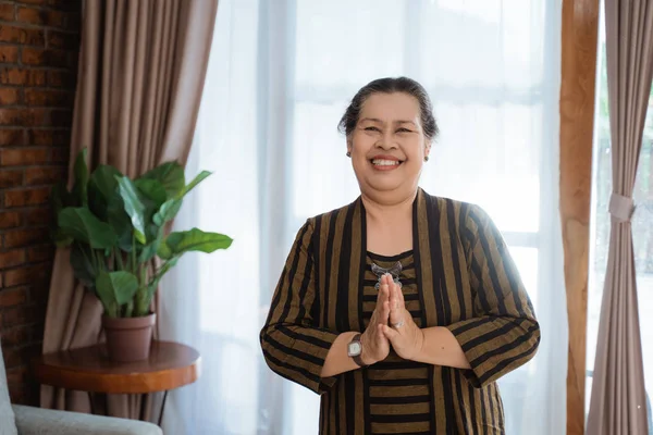 smile asian old woman woman standing wearing batik lurik