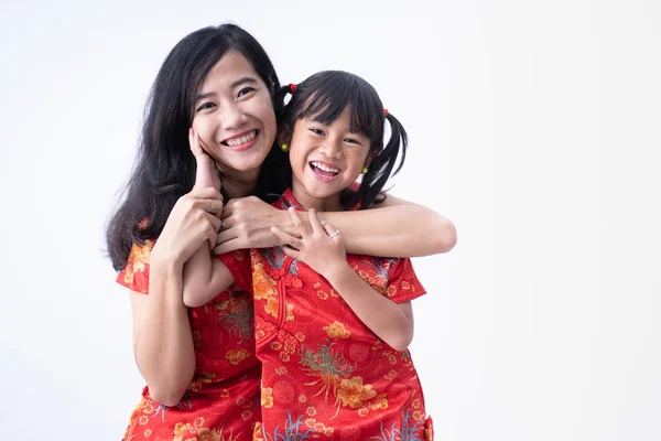 Mother and daughter wearing red dress on chinese new year — ストック写真