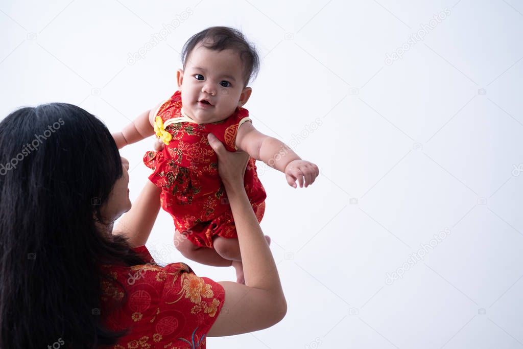 asian mother wearing chinese dress with baby