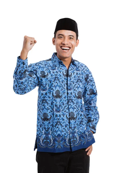 Smiling asian young man wearing batik korpri with spirited hand gesture — Stock Photo, Image