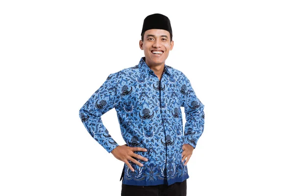 Asian young man wearing batik korpri with hand on the waist — Stock Photo, Image