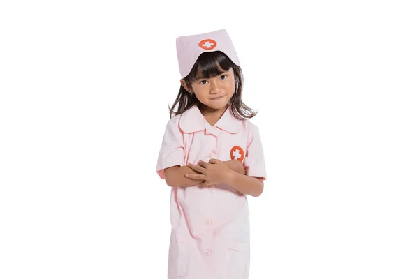 Asian little girl wearing a nurse uniform with crossed hands — Stock Photo, Image