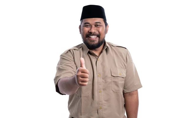 Man in brown khaki uniform showing thumb up — Stok fotoğraf