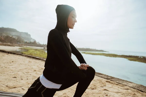 woman with muslim sport wear stretching