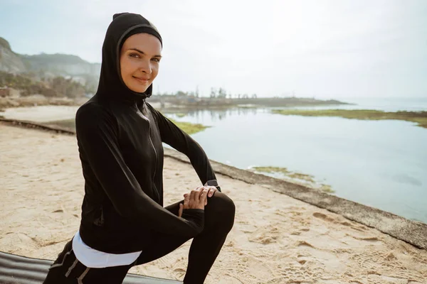 woman with muslim sport wear stretching