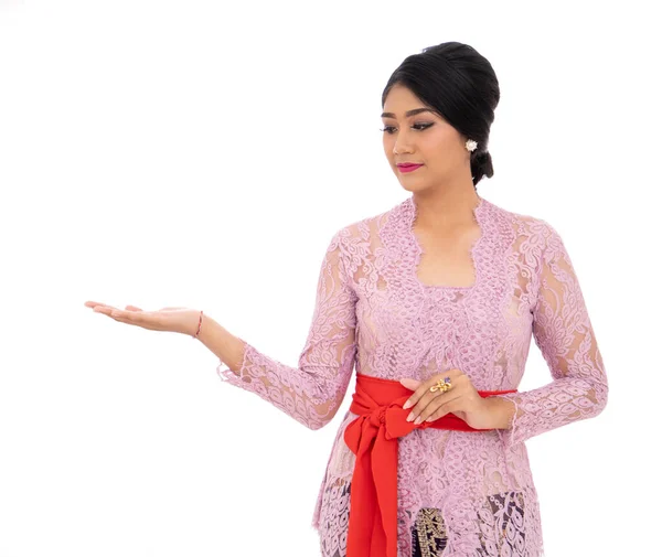 Young Balinese woman with presenting a product — Stock Photo, Image