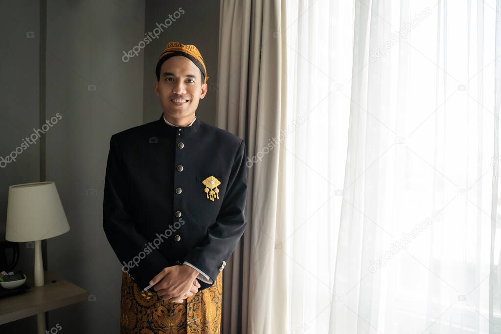 Asian man wearing traditional clothes of indonesian beskap