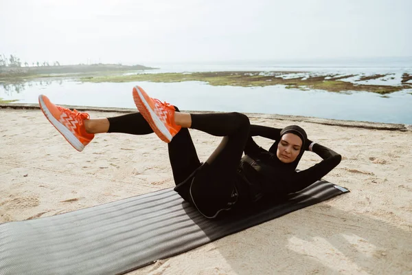 sport muslim woman with hijab sit up