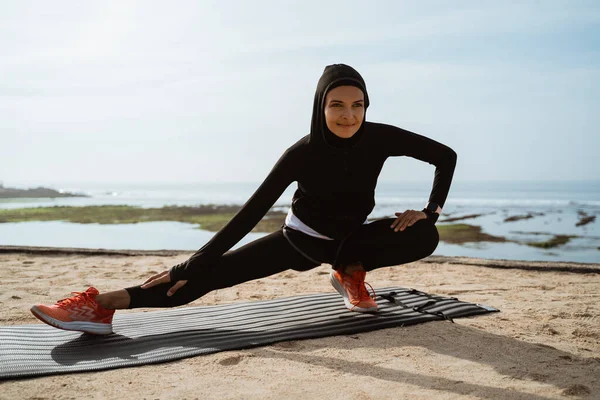 woman with muslim sport wear stretching