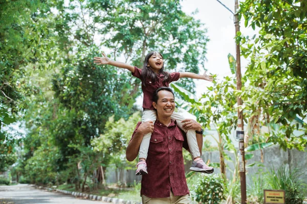 Asyalı baba boynuna gülümseyen kızı taşıyor. — Stok fotoğraf