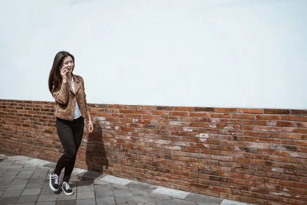 Donna che parla al telefono mentre cammina in città — Foto Stock