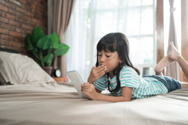 Şok olmuş bir çocuk cep telefonuna bakarken