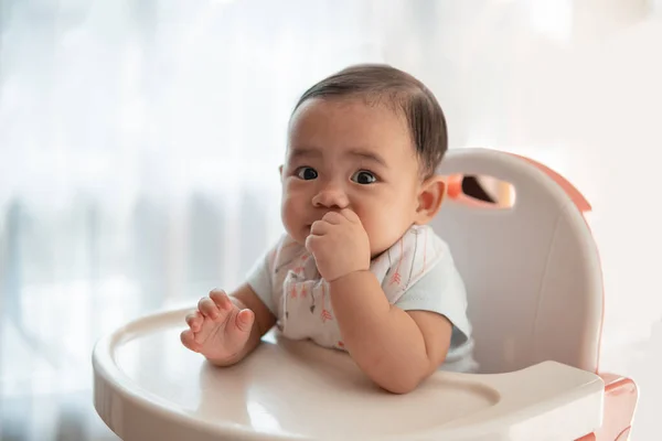 Baby feeding time sitting on highchair — Stock Photo, Image