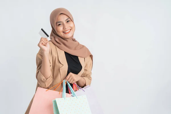 Muslim woman holding shopping bag on white — Stock Photo, Image