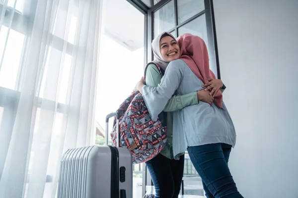 Verschleierte Frau umarmt ihre Schwester, als sie sich vor der Haustür trifft — Stockfoto