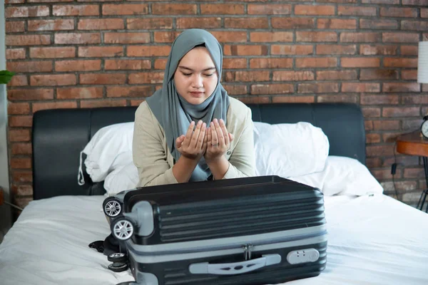 young muslim woman praying for Allah at home