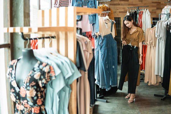 woman looking at some clothes in the fashion store