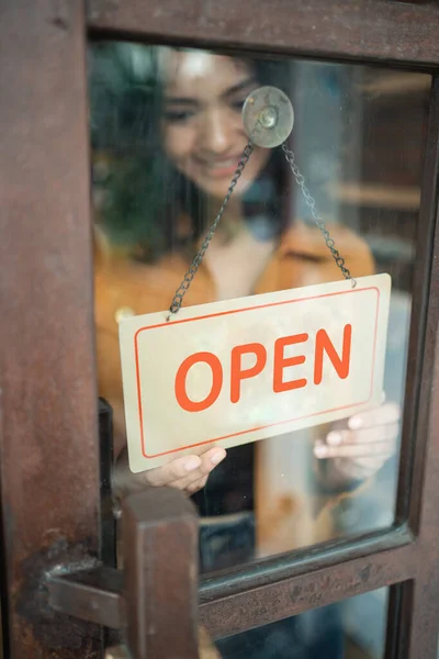 business owner turn the open sign
