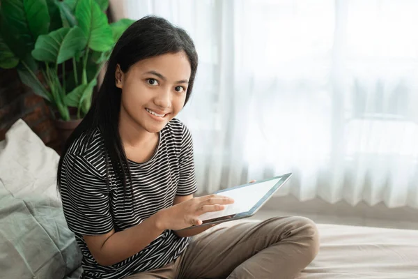 Aziatische tiener meisje met behulp van mobiele tablet — Stockfoto