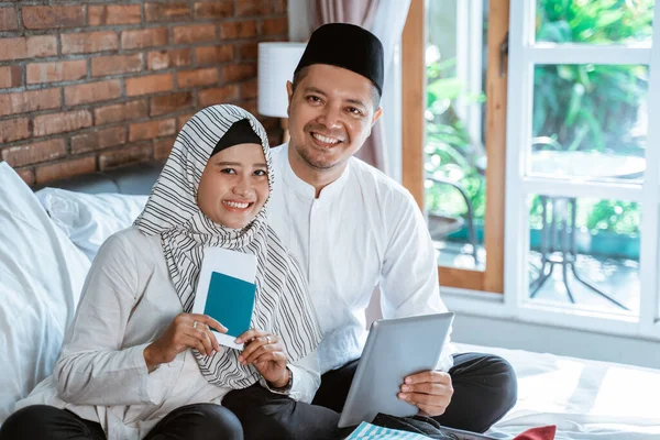 Casal muçulmano segurando passaporte e tablet — Fotografia de Stock