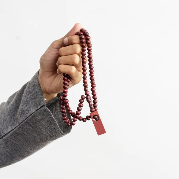 Hand holding praying muslim beads — Stock Photo, Image