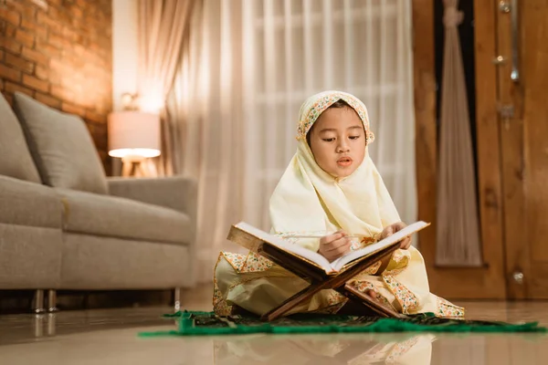 Holčička čtení quran na sobě muslimský hidžáb — Stock fotografie