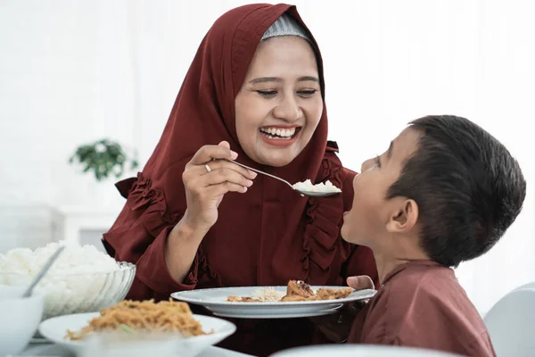 Ibu tersenyum ketika memberi makan anaknya — Stok Foto
