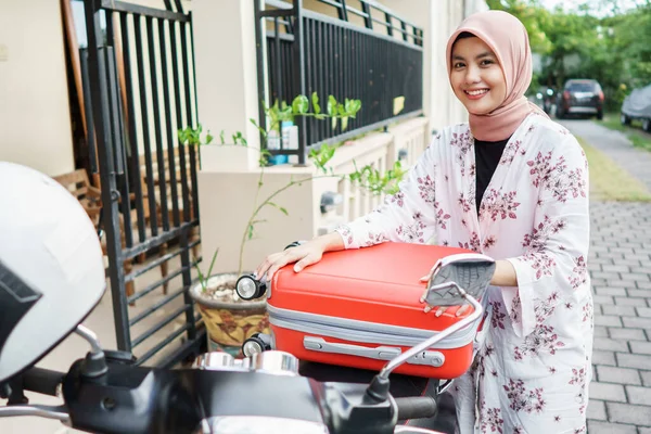 muslim woman traveling with motorbike