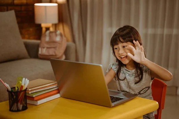 Little kid video calling using laptop at home in the evening — Stock Photo, Image
