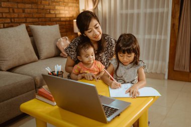 Anne ve kızı birlikte okuyorlar.