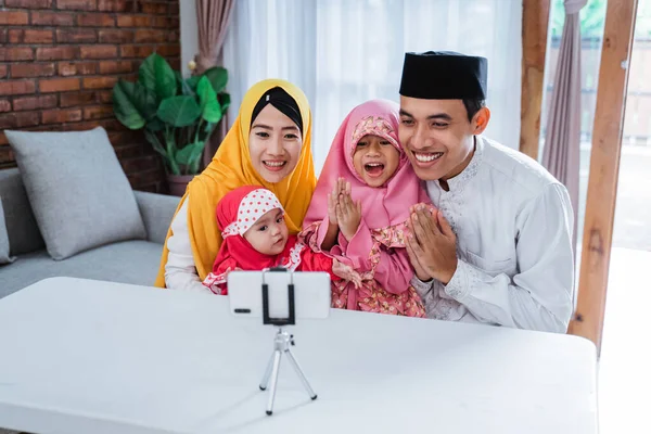 Muslim family video calling with relatives during eid mubarak — 스톡 사진